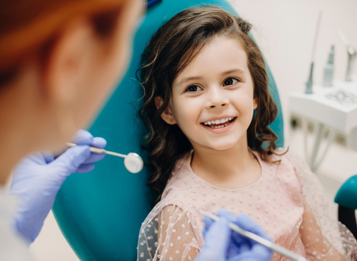little girl having teeth checked