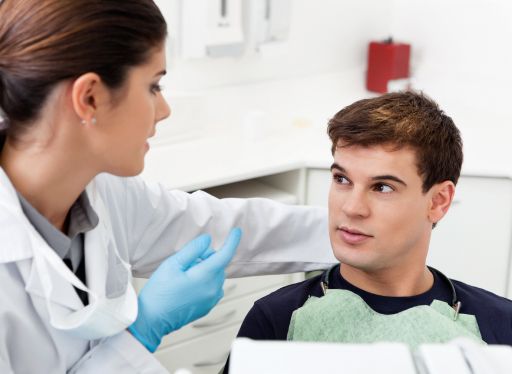 dental working talking with teenager about mouth guards